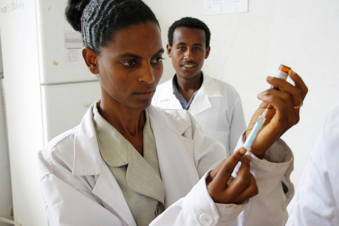 A nurse at Merawi health centre in northern Ethiopia prepares a measles vaccine for delivery. Credit: Pete Lewis/DFID. Humanitarian organization